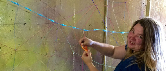 Artist Beth Benson installs her work at the 2015 Festival.  Photo:  Alisa Baker